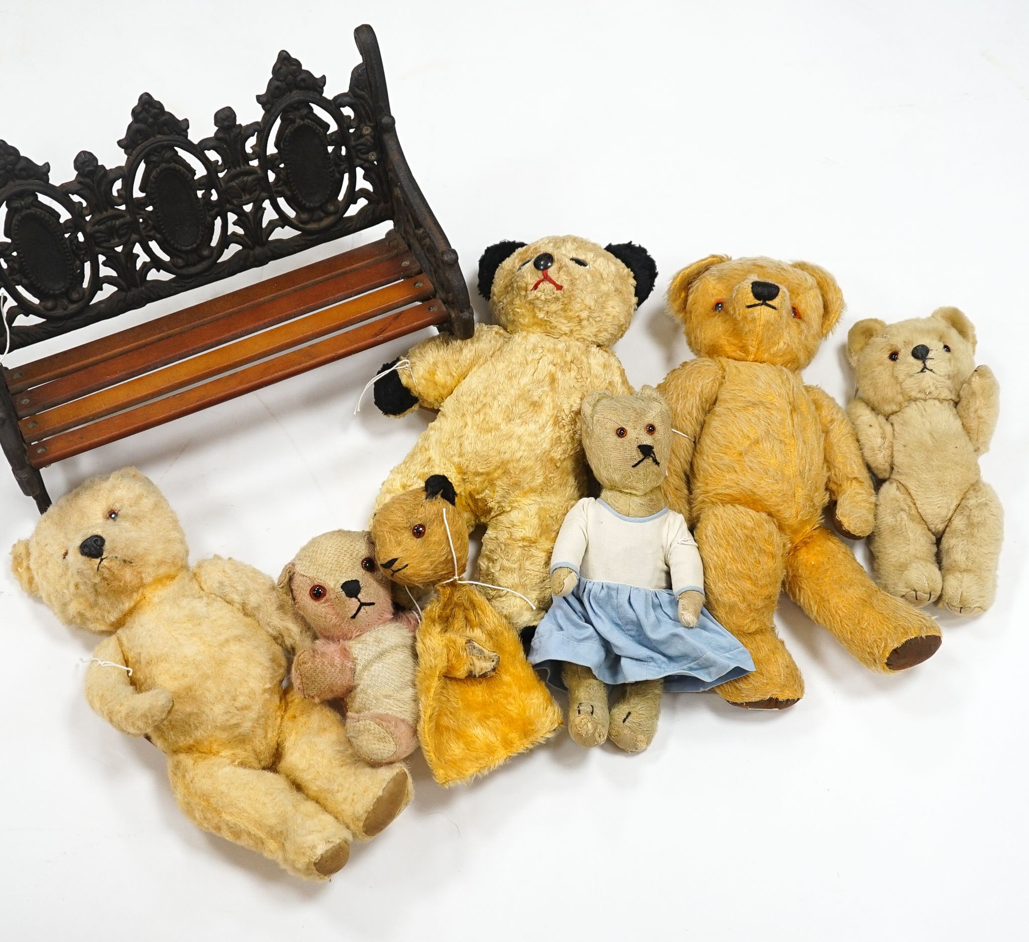 Seven English bears 1950's/60's including Chad Valley with label to Queen Mother, Sooty glove puppet and two Chilterns and a display bench